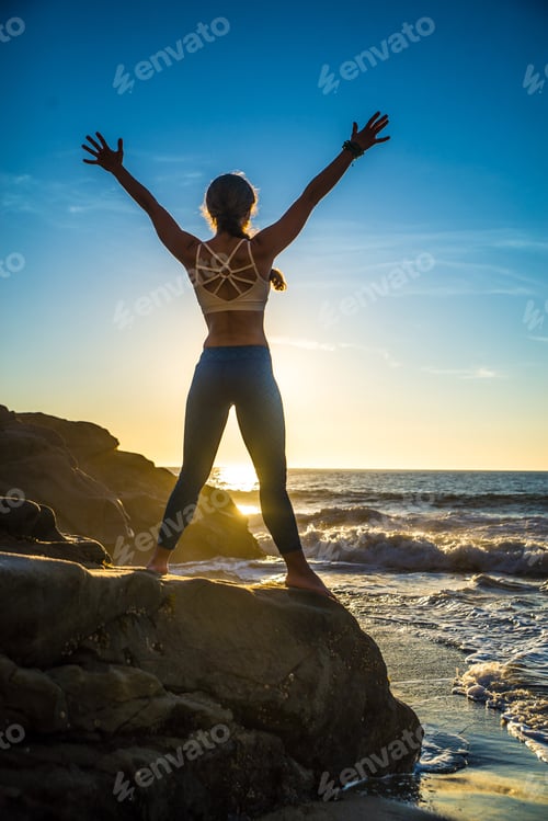 Preview: Woman doing yoga on the beach
