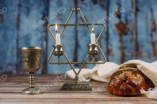 Preview: Shabbat Jewish holiday with challah bread on a candles and cup of wine.