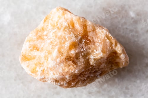 Preview: sample of uncut brown calcite rock on white