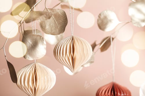 Preview: Christmas honeycomb paper decor on golden branch on beige background and bokeh. Seasonal holidays
