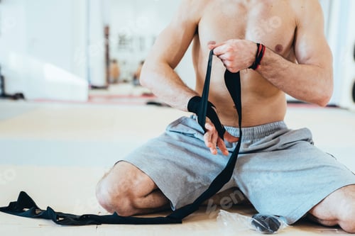 Preview: Man wrapping hand with sports tape