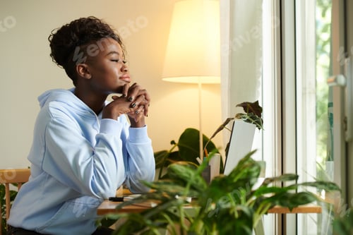 Preview: Pensive Woman Sitting at Office Desk