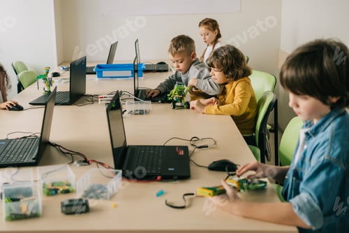 Preview: group of concentrated kids working on projects at stem education class