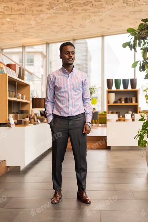 Preview: Full length portrait of handsome black businessman indoors at coffee shop