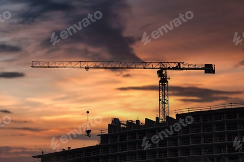 Preview: Construction cranes work on creation site against sky background