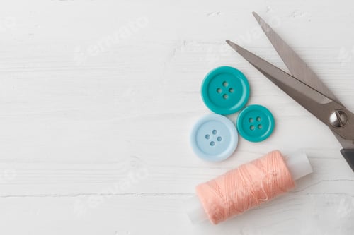 Preview: Colorful sewing accessories on white wooden table