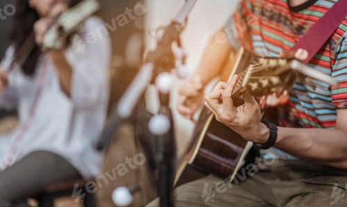 Preview: Two men were playing music, one playing guitar, the other playing the violin on stage
