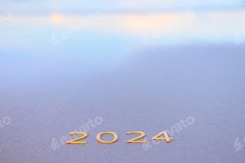 Preview: handwritten inscription 2024 on the sand by the sea, happy new year