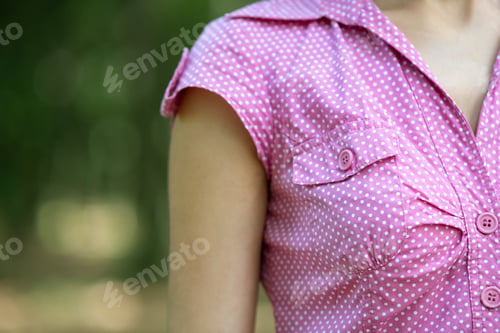 Preview: Close up of woman wearing pink summer blouse