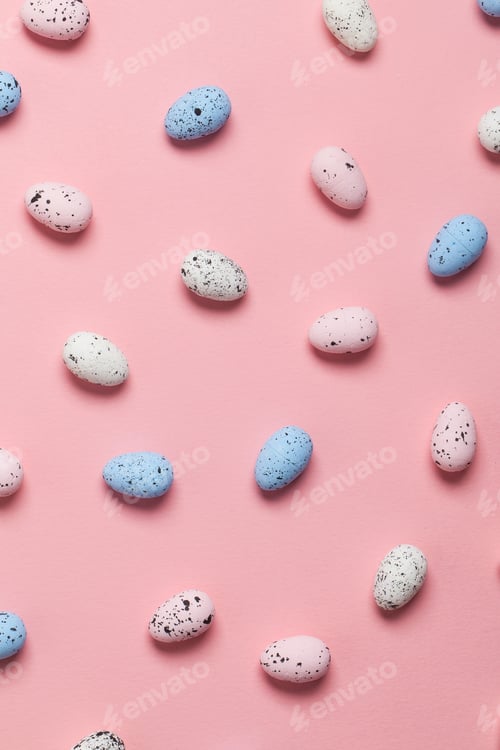 Preview: Easter eggs on a pastel pink background. Overhead view