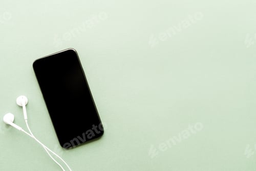 Preview: top view of smartphone with blank screen and headphones with copy space