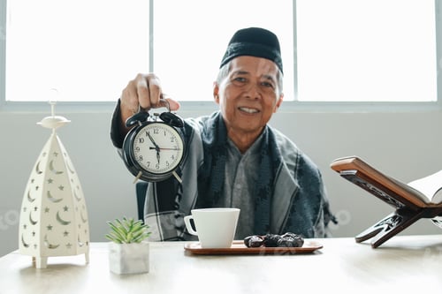Preview: Elderly Muslim Man Showing Iftar Time on Ramadan Month