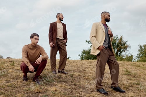 Preview: Stylish male models showcase autumn fashion in a serene natural field setting