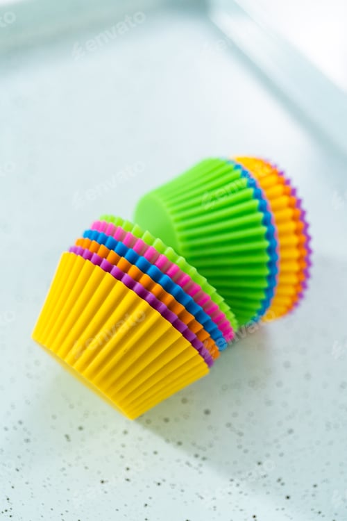 Preview: Stack of Colorful Silicone Cupcake Liners on White
