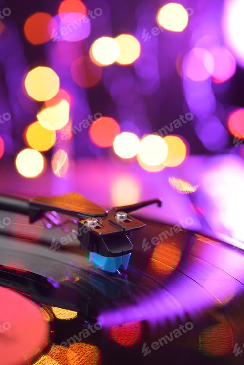 Preview: Vinyl player turntable with LP record and blured lights.
