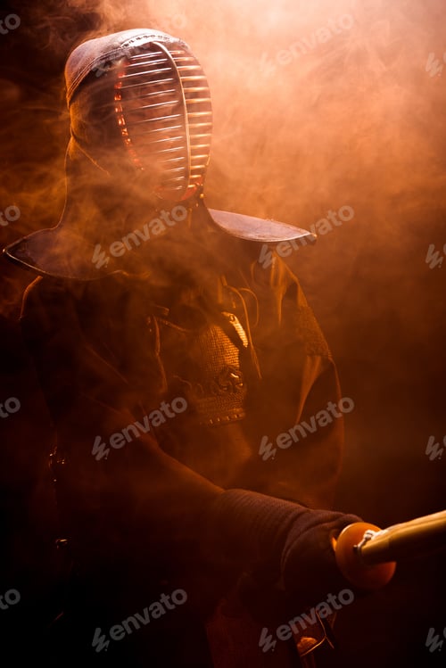 Preview: Kendo fighter in armor holding bamboo sword in smoke