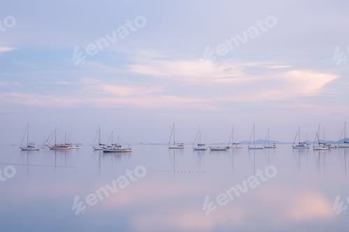 Preview: Boats on calm sea water in evening