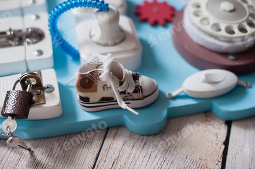 Preview: cute toddler baby playing with busy board at home