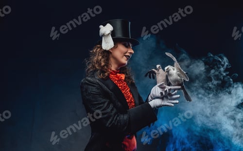 Preview: Elegant actress wearing dark clothing with trained doves in smoke