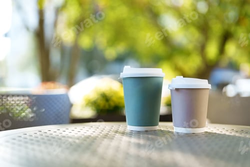 Preview: Coffee cups on a sunny table in a garden setting during the afternoon