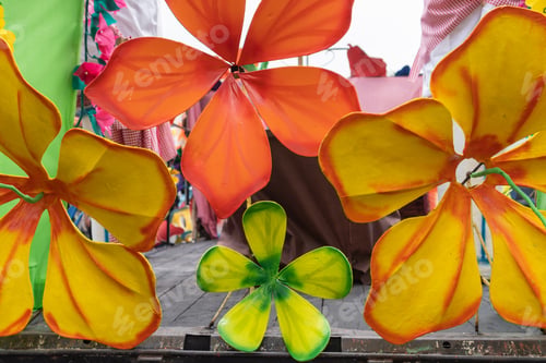 Preview: Close-up of colorful paper flowers on parade float at festival