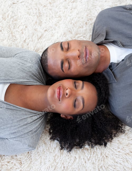 Preview: Afro-American couple sleeping on the floor