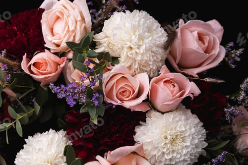 Preview: Closeup shot of a luxurious bouquet of pink roses and white flowers on a black background