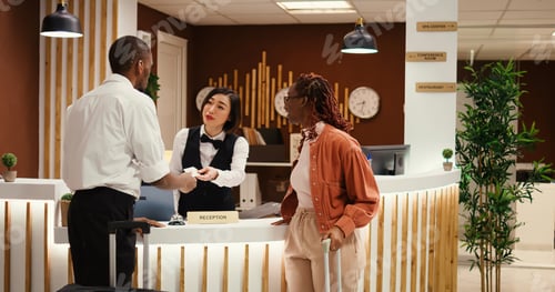 Preview: Bellboy showing tourists the way