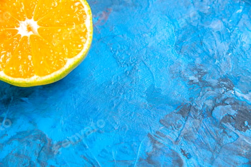 Preview: front view cut orange on blue background free space