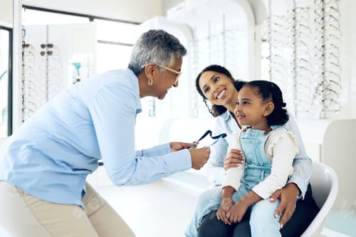 Preview: Optometrist, kid and glasses for eye care, vision or consultation in medical office for lens. Woman
