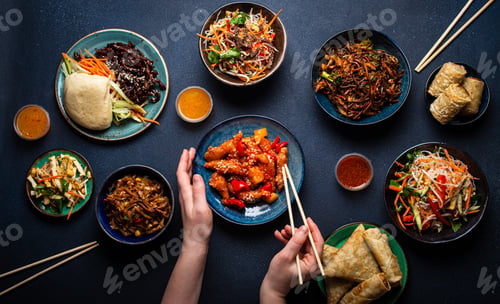 Preview: Set of Chinese dishes on table, female hands holding chopsticks