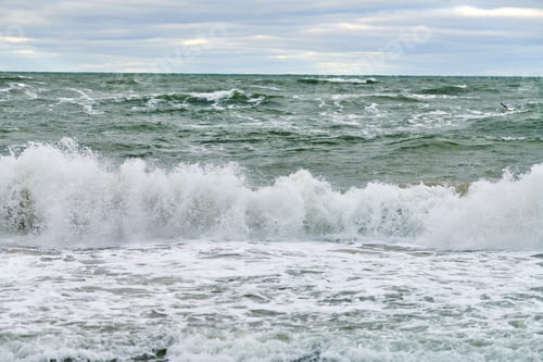Preview: Blue sea with foaming waves and cloudy sky, seascape