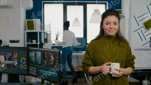 Preview: Portrait of creative designer smiling at camera holding a cup of coffee