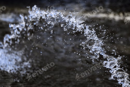 Preview: Water splashing from the fountain, jet, aqua drops, clear liquid splash on dark background