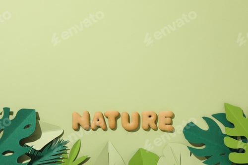 Preview: The word: "nature" laid out from cookies on a green background.