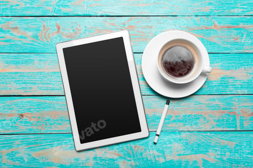 Preview: digital tablet and coffee cup on wooden table