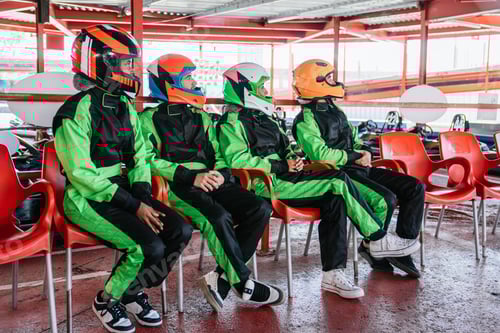 Preview: People with Helmets Sit on Red Plastic Chairs