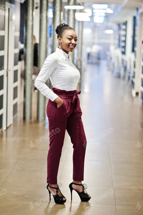 Preview: African woman in dress posing at restaurant