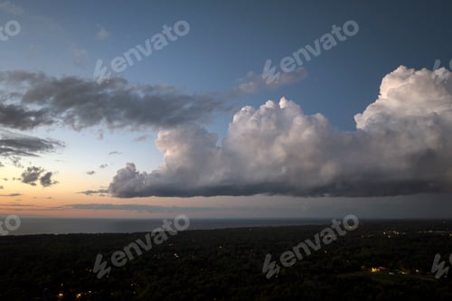 Preview: Evening sunset sky with colorful clouds over dark land. Panoramic skyscape