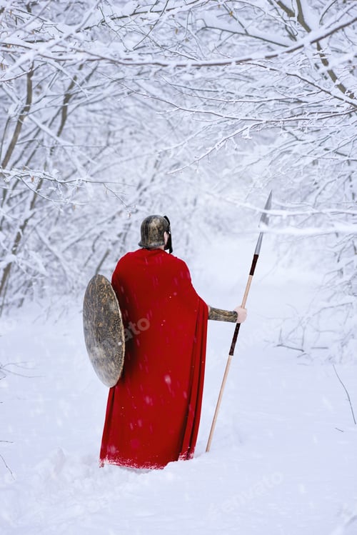 Preview: Close up of spartan warrior walking through winter forest
