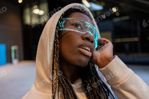 Preview: Futuristic Young Woman in Neon Glasses and Hoodie