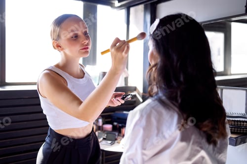 Preview: A charming blonde makeup artist applies makeup to her attractive client