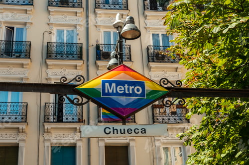 Preview: Sign of the metro station in the Chueca neighborhood of Madrid adronado with colors of the lgtb