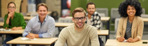 Preview: Business lecture. Group of happy multiracial people sitting in the modern office and listening to