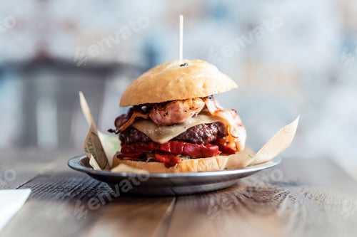 Preview: Delicious fresh homemade big burguer on a rustic wooden table in the restaurant.
