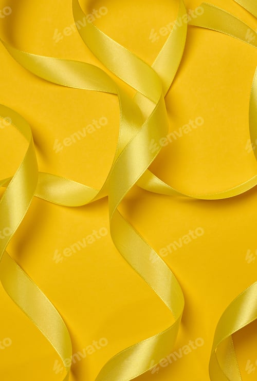 Preview: Yellow satin ribbons scattered chaotically, curves and loops, yellow background.