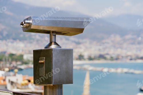Preview: Binoculars on city sea cost background