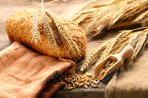 Preview: Rye spikelets and bread on wooden background