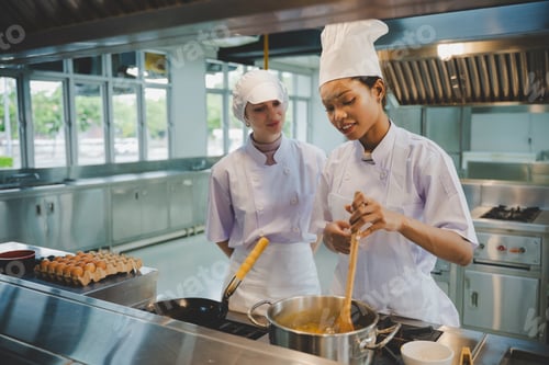 Preview: Group of culinary students practicing cooking skills with fresh
