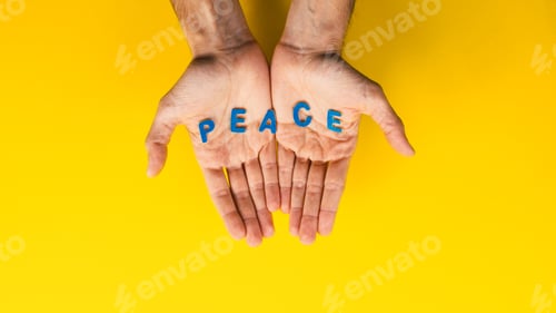 Preview: man holding a peace inscription in the colors of the ukrainian flag
